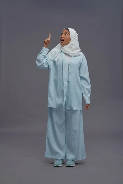 امرأة سعودية تشير للأعلى بتعبير وجه مندهش