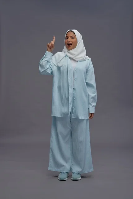 Saudi Woman Pointing Up Surprised Studio Portrait
