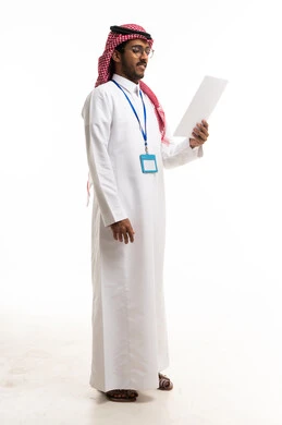 Saudi Man in Traditional Thobe Reading Paper on White Background