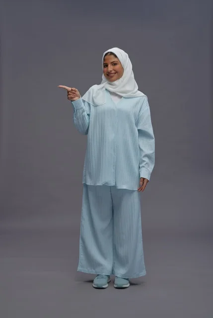 Smiling Saudi Woman Pointing Side in Modest Outfit
