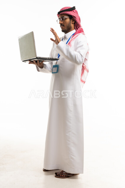 Saudi Man in Traditional Thobe Using Laptop Video Call