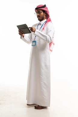 رجل أعمال سعودي يستخدم جهاز لوحي على خلفية بيضاء