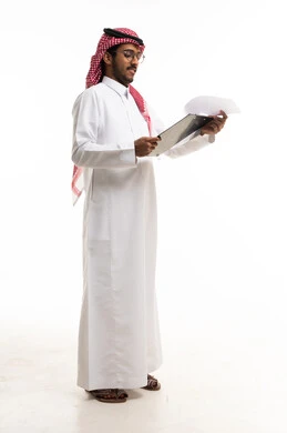 Saudi Man Reviewing Documents on White Background