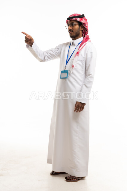 Saudi Man in Traditional Thobe Pointing on White Background