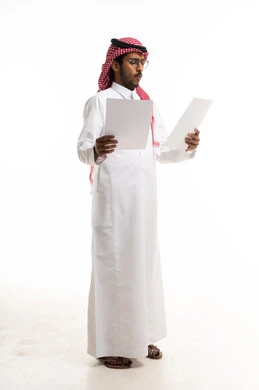 Saudi Man in Traditional Thobe Reviewing Documents