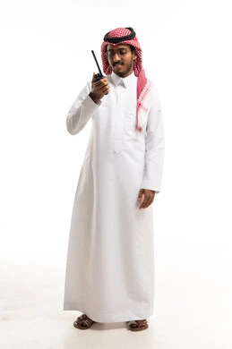 Saudi Man in Traditional Thobe Using Walkie-Talkie