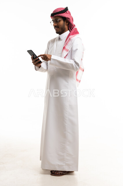 Saudi Man in Thobe Using Smartphone on White Background