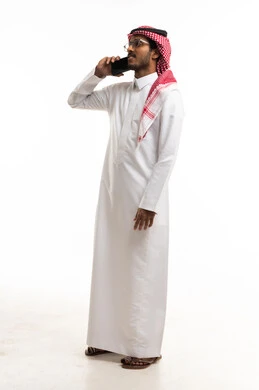 Saudi Man in Traditional Thobe Using Smartphone