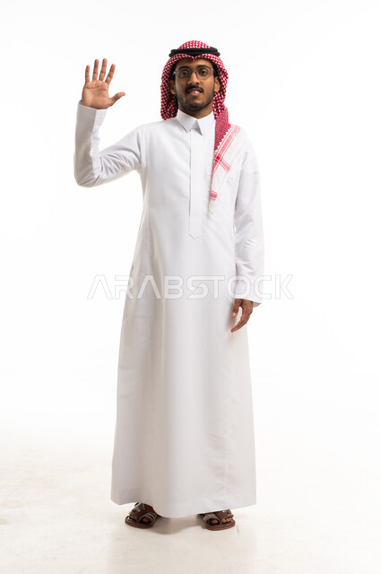 Saudi Man in Traditional Thobe Waving in Studio