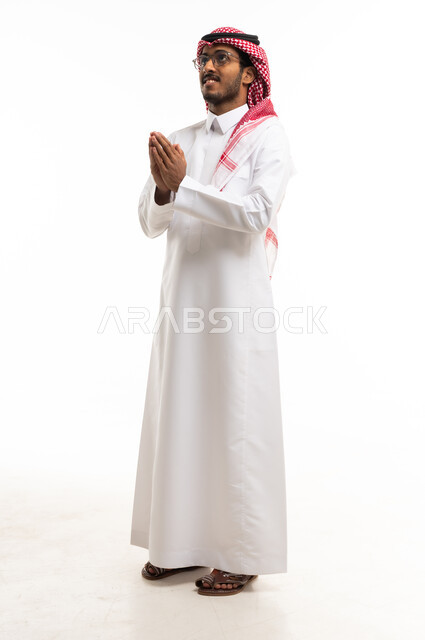 Saudi Man in Traditional Thobe with Prayer Gesture