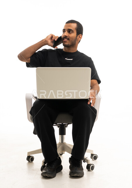 Saudi Man with Laptop and Phone on White Background