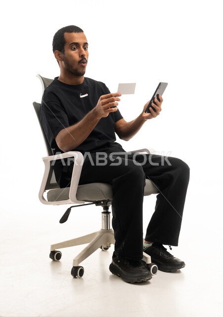 Surprised Arab Man Holding Smartphone and Credit Card