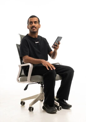 Middle Eastern Man on Office Chair with Smartphone