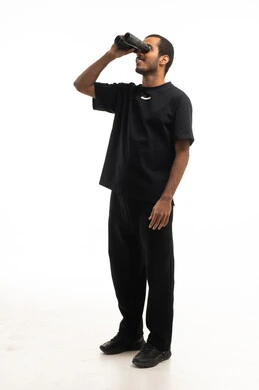 Saudi Man Looking Through Binoculars on White Background