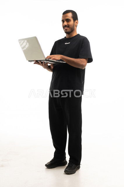 Middle Eastern Man Holding Laptop on White Background