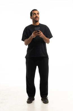 Saudi Man Holding Smartphone Looking Up in Studio