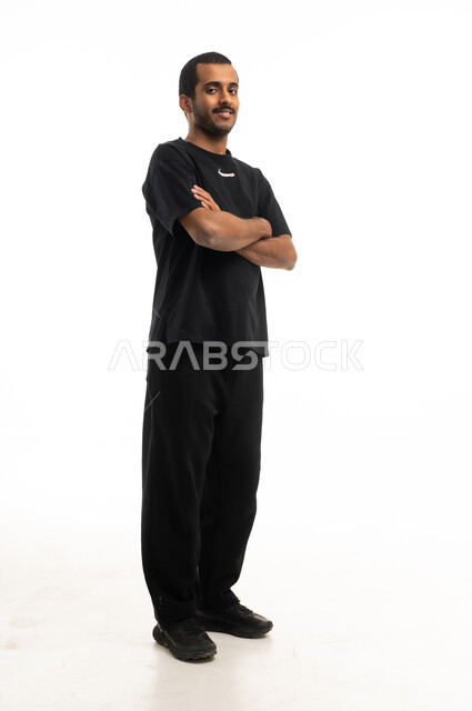 Saudi Man Standing with Crossed Arms on White Background