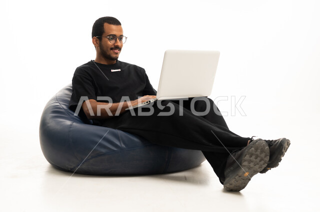 Saudi Man Working on Laptop on White Background