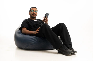 Saudi Man with Smartphone on Blue Bean Bag