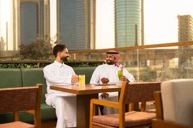 Arab Men at Outdoor City Restaurant During Sunset