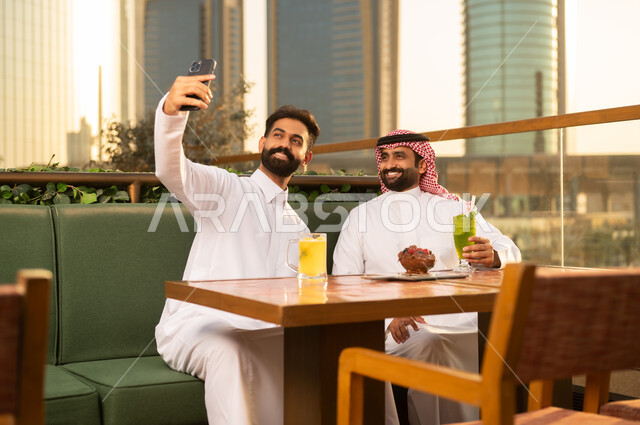 Saudi Men Taking Selfie at Urban Outdoor Restaurant