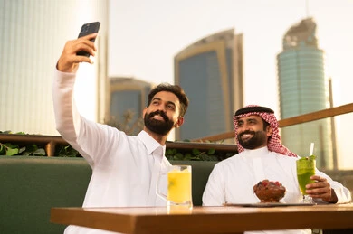 Saudi Men Taking Selfie at Outdoor City Restaurant