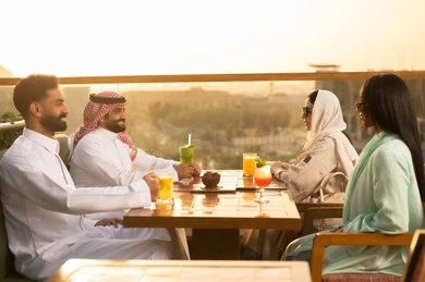 Group of Arab Friends at a Rooftop Restaurant During Sunset