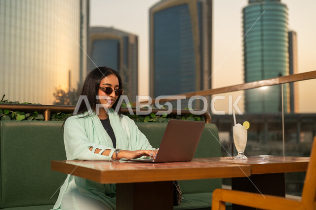 Saudi Businesswoman Working on Laptop in Riyadh Cafe