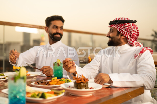 Saudi Men Dining at Rooftop Restaurant During Sunset