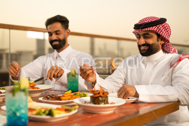 Saudi Men Dining at Outdoor Rooftop Restaurant at Sunset