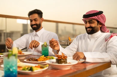 Saudi Men Dining at Outdoor Rooftop Restaurant at Sunset