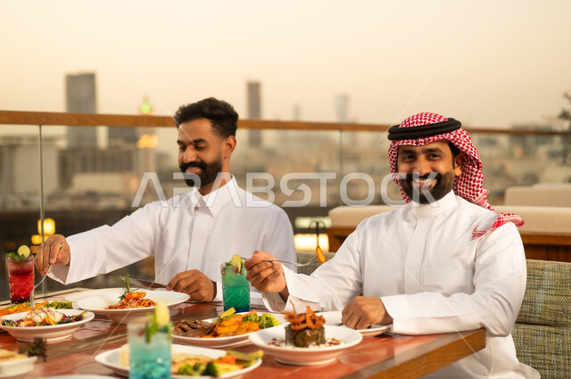 Saudi Men Dining at Rooftop Restaurant at Sunset