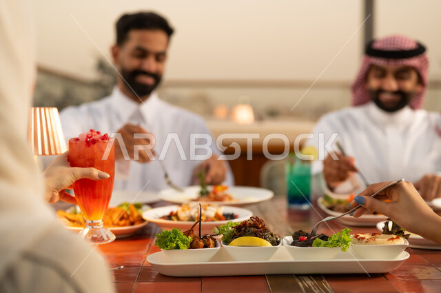 Saudi Men Enjoying Arabic Dinner at Restaurant