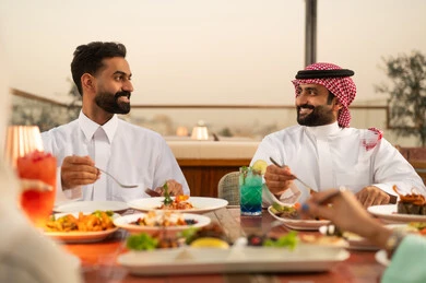 Arab Men Dining at Rooftop Restaurant Sunset