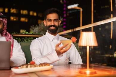 Saudi Man in Thobe at Night Rooftop Lounge