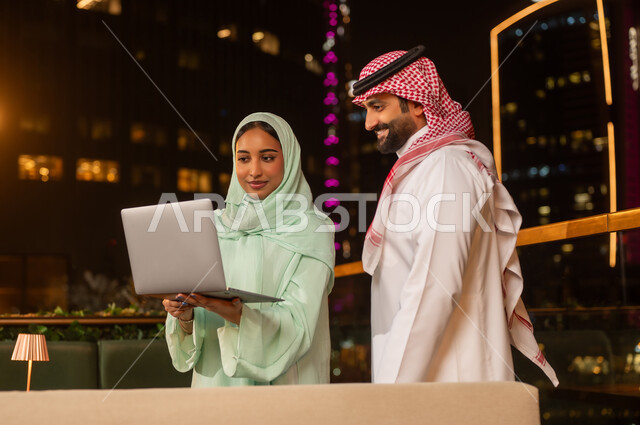 Saudi Business Couple Working on Laptop at Night