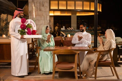 Saudi Friends Celebrating Birthday at Outdoor Restaurant