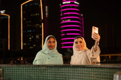 Khaleeji Women Taking Selfie with City Night Skyline