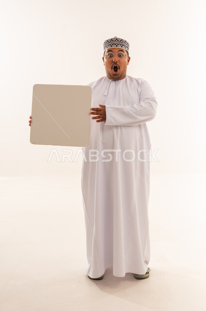Surprised Omani Man Holding Blank White Sign