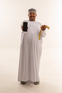 Omani Man Holding Smartphone and Measuring Tape