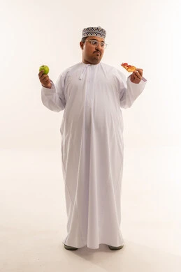 Omani Man Choosing Between Pizza and Apple Studio Shot