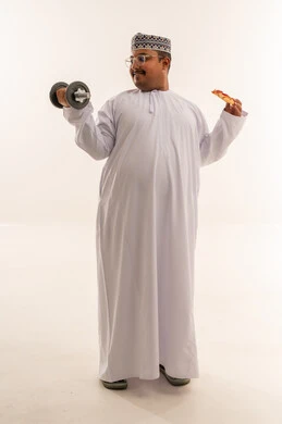 Omani Man Holding Dumbbell and Pizza in Studio