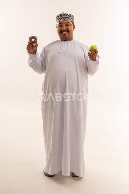 Omani Man Choosing Between Healthy Apple and Donut