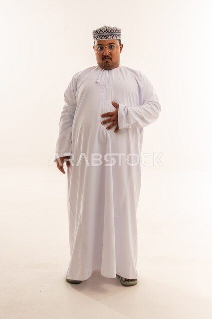 Overweight Omani Man Holding Stomach in Studio