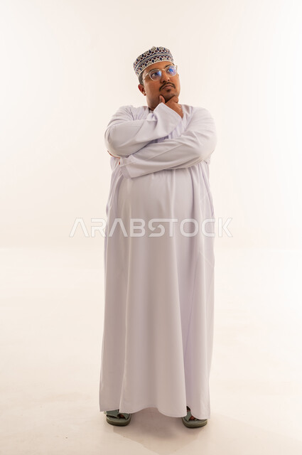 Overweight Omani Man Thinking in Traditional Dress