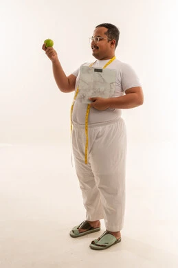Overweight Saudi Man with Scale and Green Apple