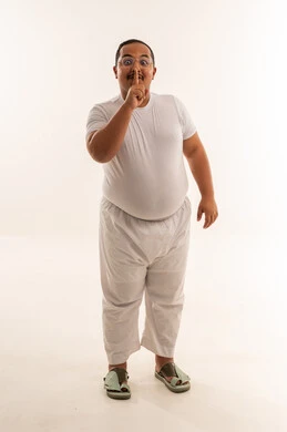 رجل سعودي يشير بالصمت أمام خلفية بيضاء