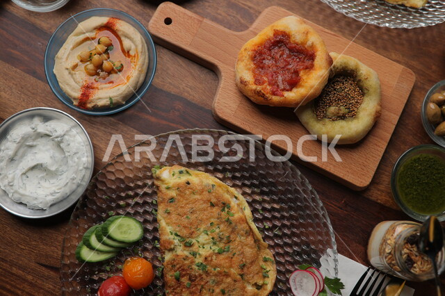A picture of a delicious breakfast meal, manakish and omelettes, cold appetizers, Arabic meals, delicious recipes and dishes, healthy foods, Saudi Arabian Gulf restaurants