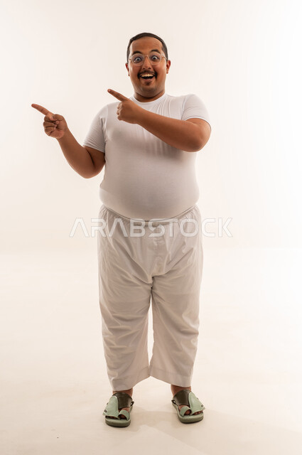 Overweight Saudi Man Pointing on White Background