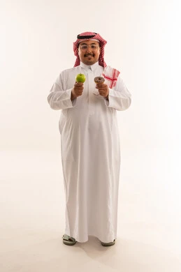 Overweight Saudi Man Holding Apple and Donut in Studio